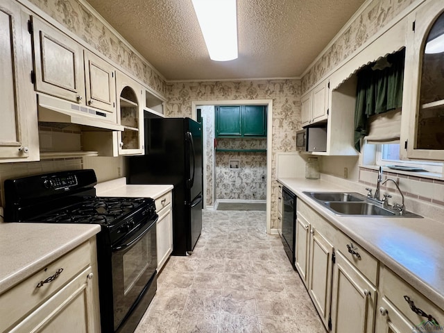 1400 Shreveport St, Elysian Fields, TX 75642 - kitchen featuring black appliances, under cabinet range hood, wallpapered walls, a textured ceiling, and light countertops