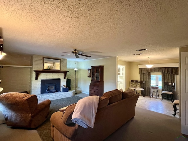 carpeted living room with ceiling fan, a wood stove, and a textured ceiling