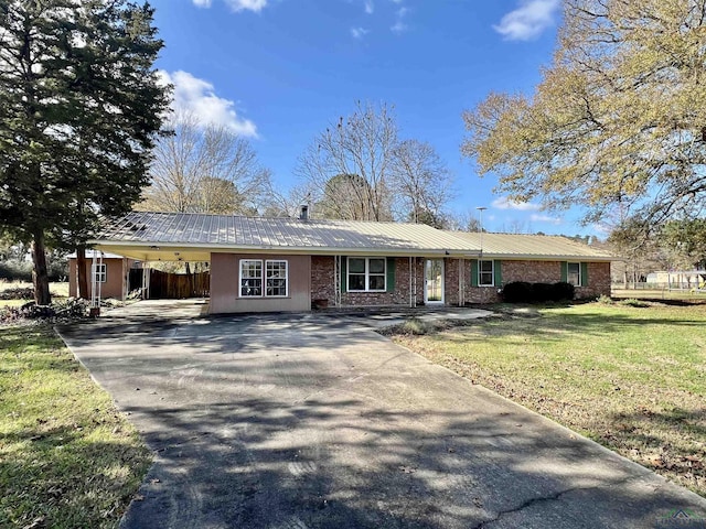 1400 Shreveport St, Elysian Fields, TX 75642 - ranch-style home with driveway, a metal roof, an attached carport, and brick siding
