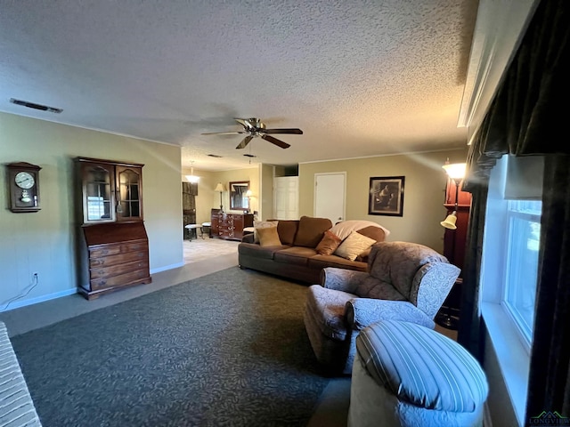 carpeted living room with ceiling fan and a textured ceiling