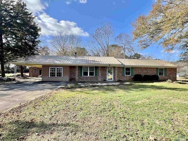 1400 Shreveport St, Elysian Fields, TX 75642 - ranch-style house with a front lawn, an attached carport, concrete driveway, and a metal roof