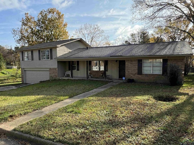 view of front of home with a front lawn, covered porch, and a garage