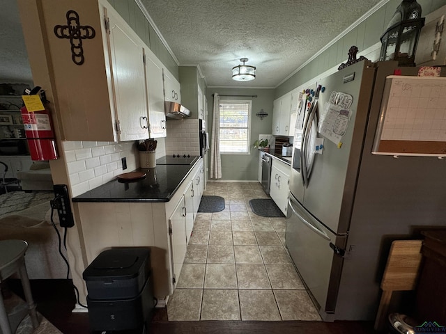 kitchen with tasteful backsplash, stainless steel appliances, crown molding, light tile patterned floors, and white cabinets