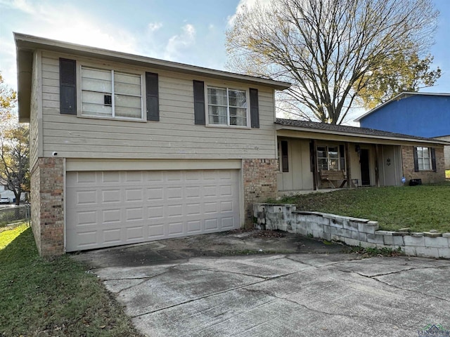 tri-level home with a front yard and a garage