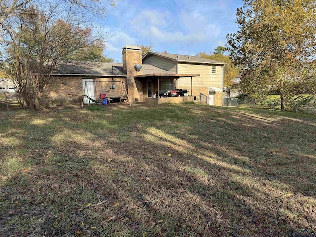 rear view of property featuring a yard