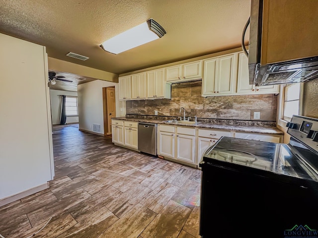 kitchen featuring electric range, a sink, visible vents, and stainless steel dishwasher