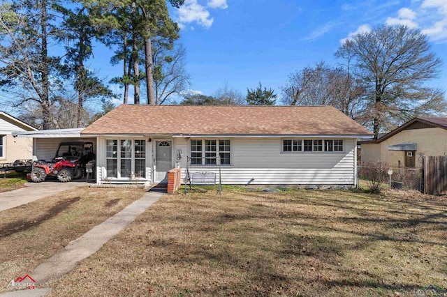 single story home featuring a carport and a front yard