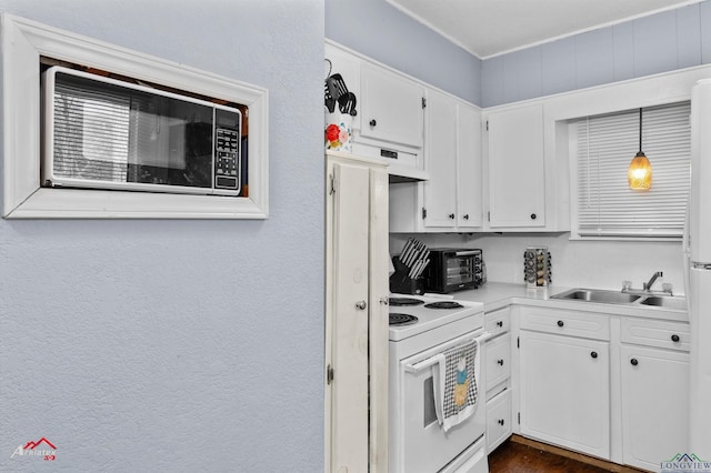 kitchen featuring white cabinetry, sink, electric range, and decorative light fixtures