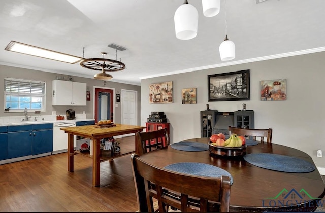 145 Cherry St, Tatum, TX 75691 - dining room with ornamental molding and wood finished floors