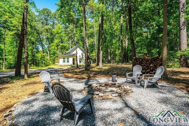 299 Southshore Dr, Lone Star, TX 75668 - view of yard with a fire pit and a wooded view