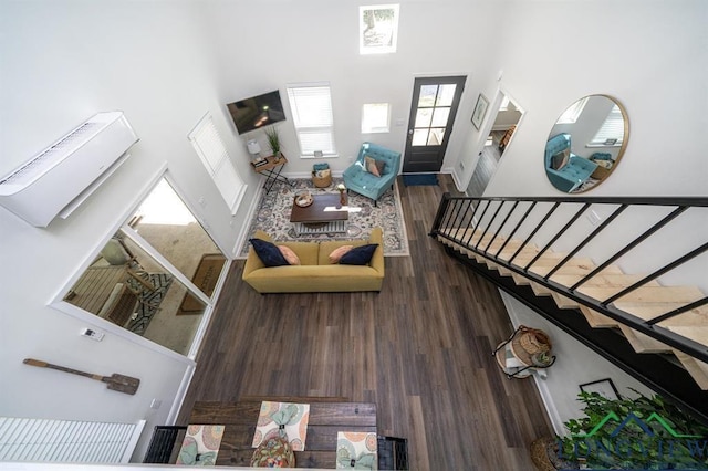299 Southshore Dr, Lone Star, TX 75668 - living room with a towering ceiling, stairs, plenty of natural light, and wood finished floors