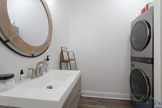 299 Southshore Dr, Lone Star, TX 75668 - bathroom with stacked washer / dryer, wood finished floors, baseboards, and vanity