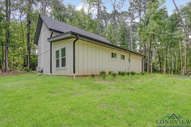 299 Southshore Dr, Lone Star, TX 75668 - view of property exterior with a yard, a shingled roof, board and batten siding, and central air condition unit