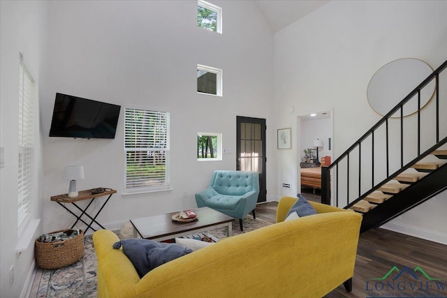 299 Southshore Dr, Lone Star, TX 75668 - living room with wood finished floors, high vaulted ceiling, baseboards, and stairway