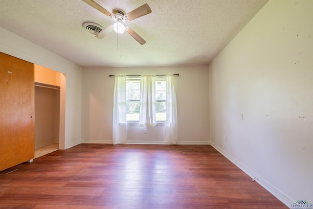 interior space with hardwood / wood-style floors, a textured ceiling, and ceiling fan