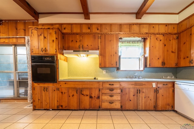 kitchen featuring white dishwasher, oven, light tile patterned flooring, and sink