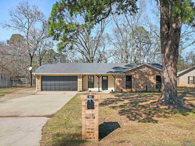 ranch-style house with an attached garage, brick siding, fence, driveway, and a front lawn