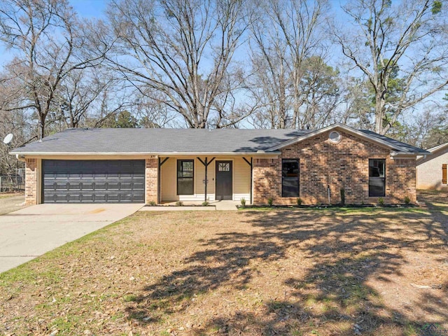 ranch-style house featuring a garage, driveway, a front lawn, and brick siding