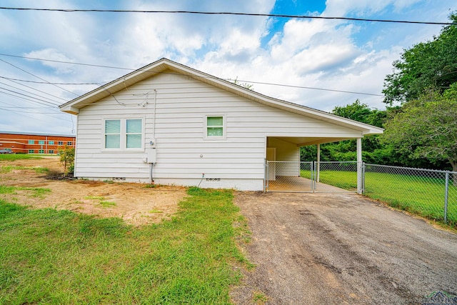 view of property exterior featuring a carport and a lawn