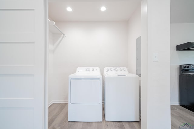 washroom featuring light hardwood / wood-style floors and separate washer and dryer