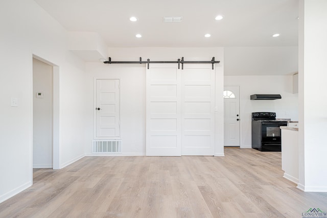 interior space featuring a barn door and light wood-type flooring