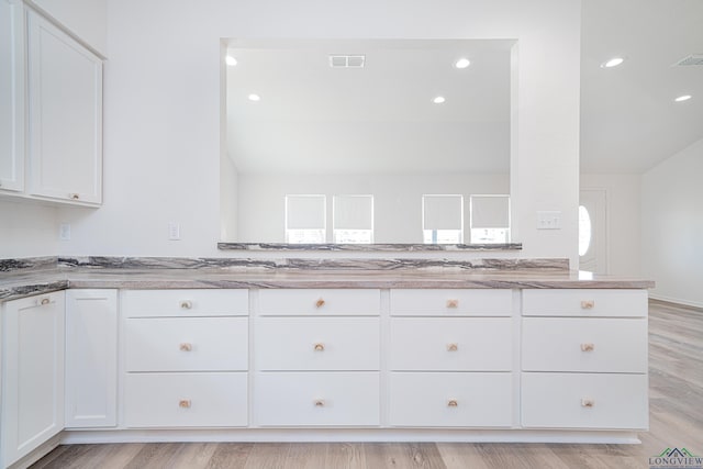 kitchen featuring white cabinets and light hardwood / wood-style floors