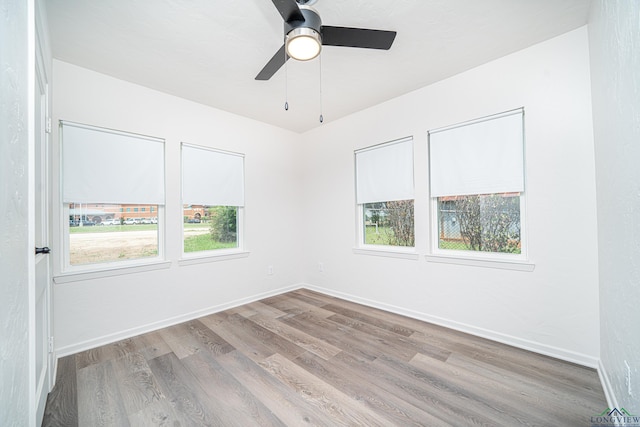 unfurnished room featuring ceiling fan and light hardwood / wood-style flooring