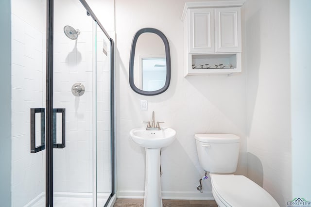 bathroom with an enclosed shower and toilet