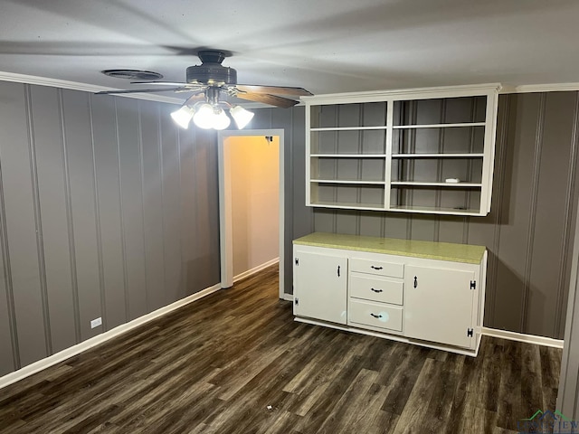 unfurnished bedroom featuring ceiling fan, dark hardwood / wood-style floors, and ornamental molding