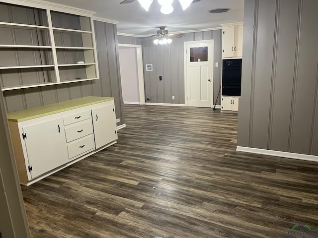 interior space featuring ceiling fan, dark hardwood / wood-style flooring, and ornamental molding