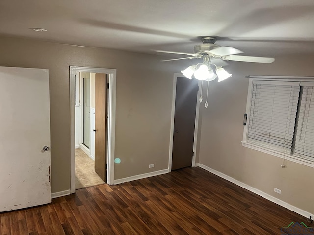 unfurnished bedroom with ceiling fan and dark wood-type flooring