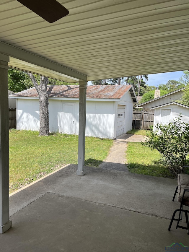 view of patio featuring an outdoor structure and a garage