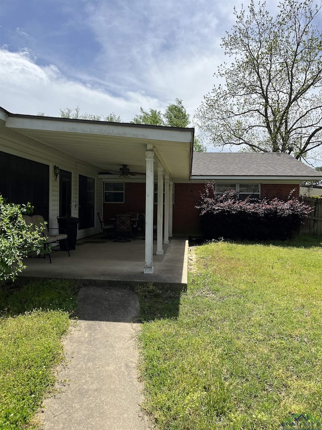 exterior space with ceiling fan