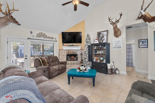 tiled living room featuring ceiling fan, lofted ceiling, and a fireplace