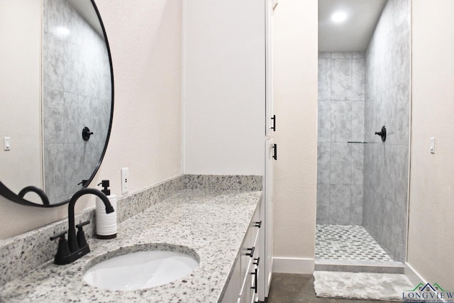 bathroom featuring vanity and a tile shower