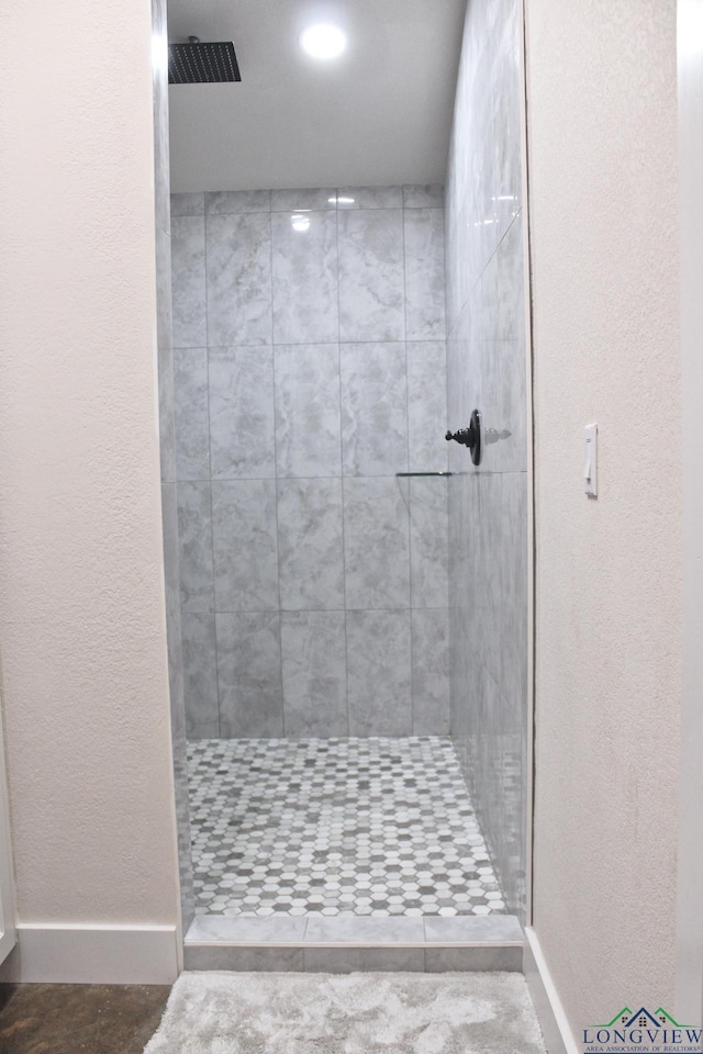 bathroom with a tile shower