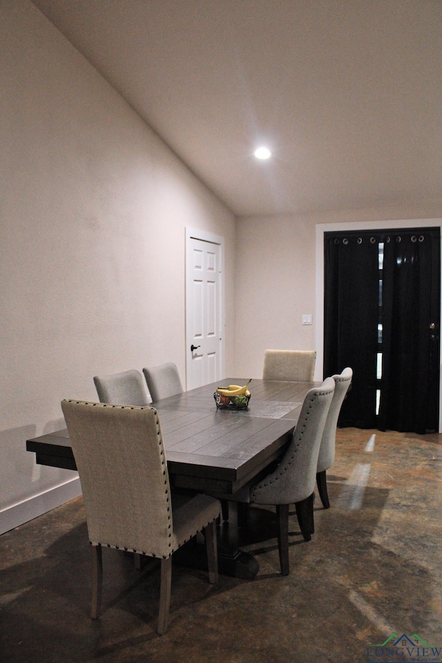 dining space featuring lofted ceiling