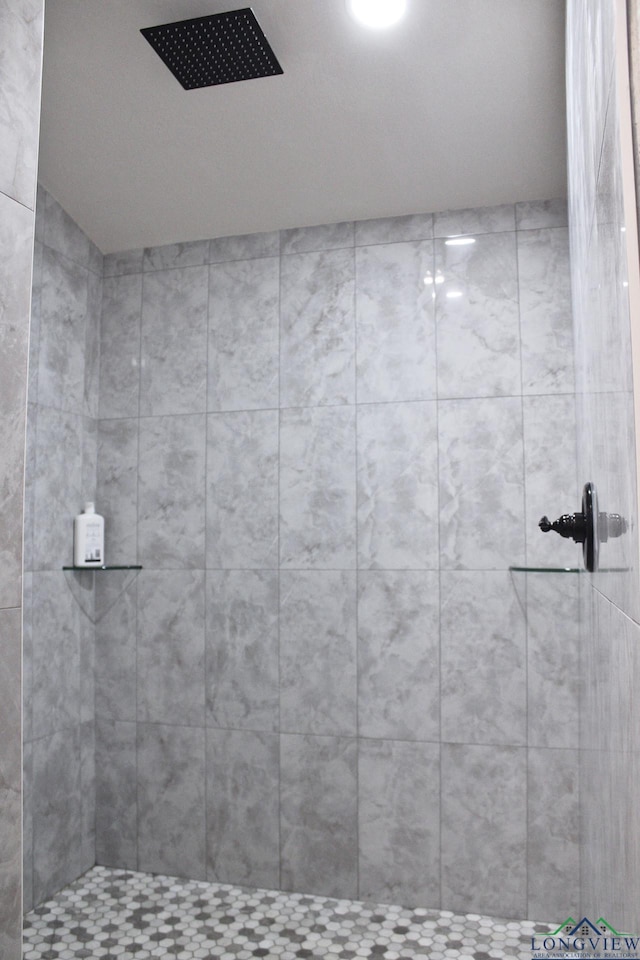 bathroom with a tile shower