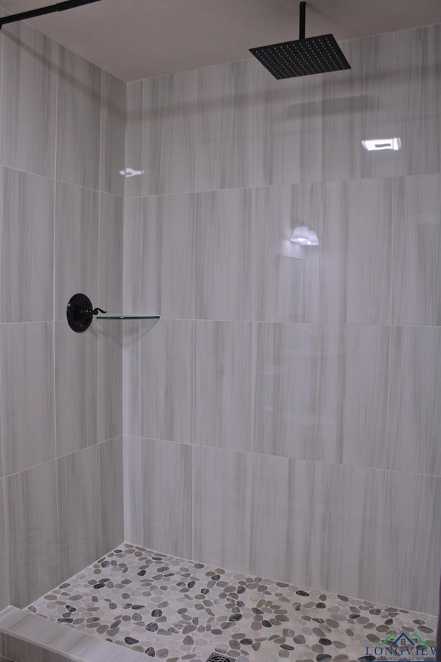 bathroom with tiled shower