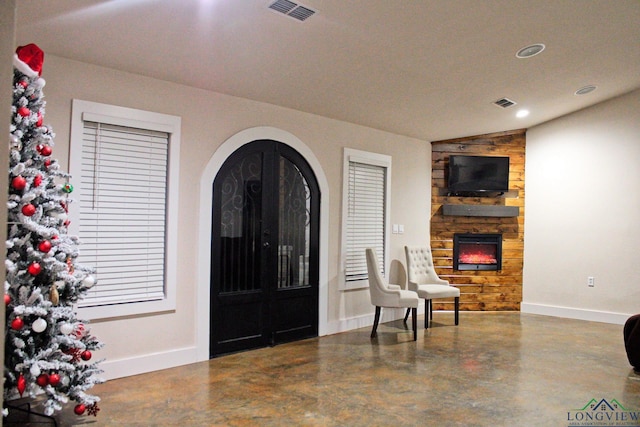 foyer entrance with a stone fireplace