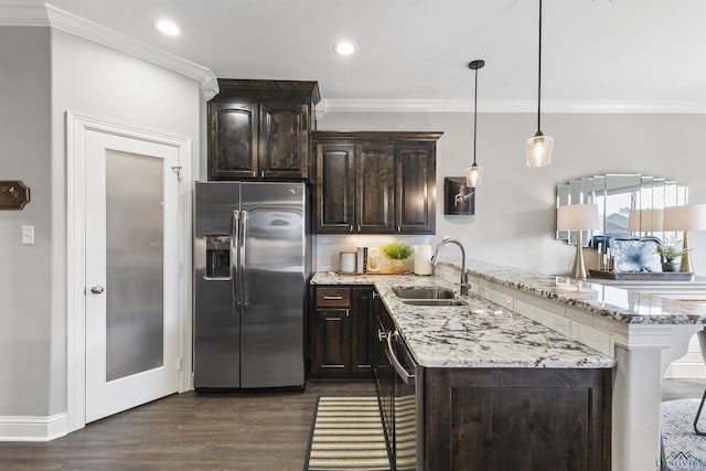 kitchen featuring ornamental molding, a sink, stainless steel appliances, a peninsula, and dark brown cabinets