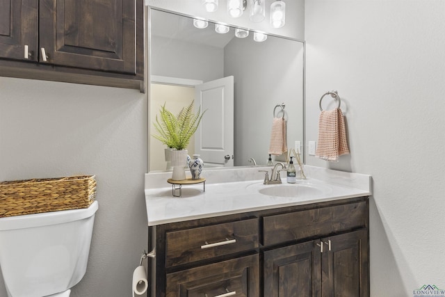 bathroom featuring toilet and vanity