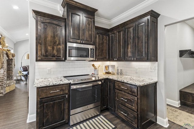 kitchen featuring crown molding, light stone countertops, dark wood-style flooring, and appliances with stainless steel finishes