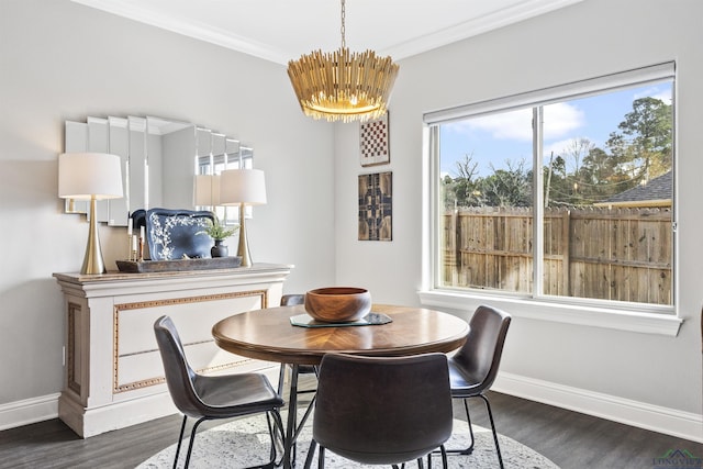 dining space with dark wood-style floors, baseboards, a chandelier, and ornamental molding