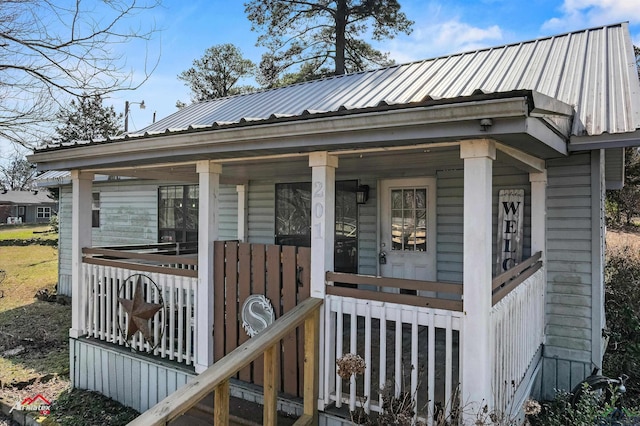 view of front of house with metal roof and a porch