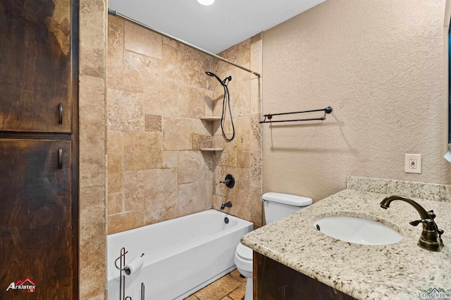 full bath featuring a textured wall, vanity, toilet, and shower / bathtub combination