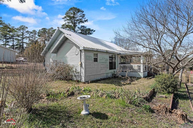 view of side of home featuring metal roof