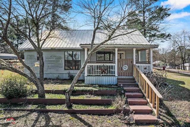 view of front of property featuring covered porch and metal roof