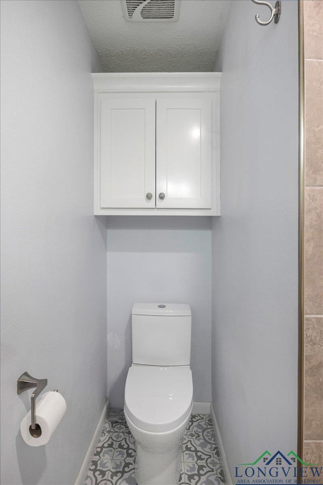 1611 Springdale St, Longview, TX 75604 - bathroom with baseboards and toilet