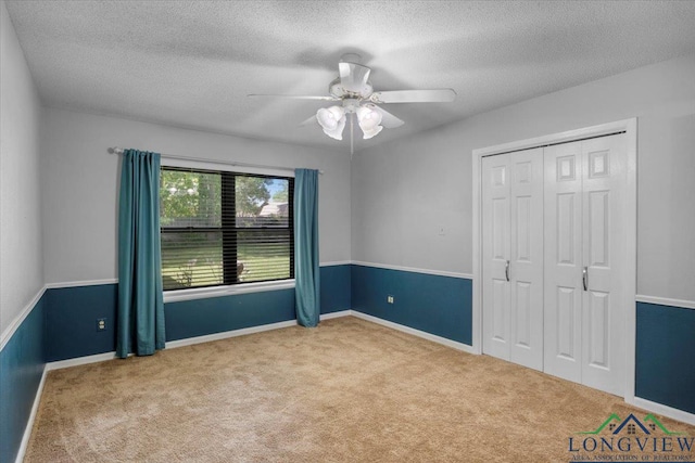 1611 Springdale St, Longview, TX 75604 - unfurnished bedroom featuring carpet floors, a textured ceiling, a closet, ceiling fan, and baseboards